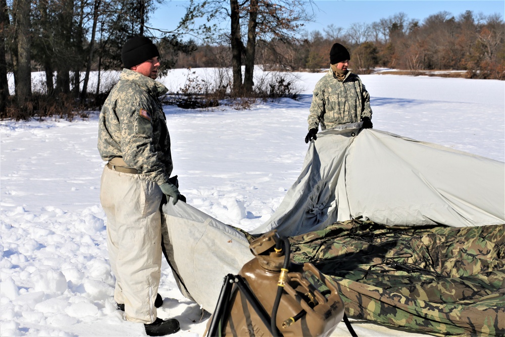 Cold-Weather Operations Course students practice building Arctic tent