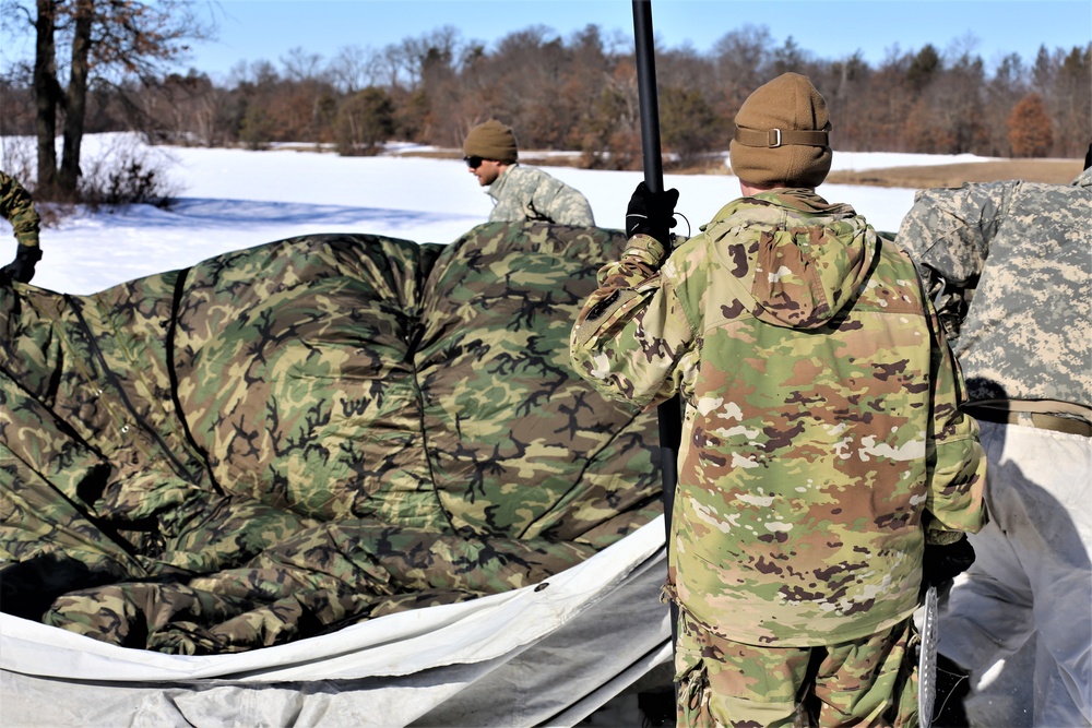 Cold-Weather Operations Course students practice building Arctic tent