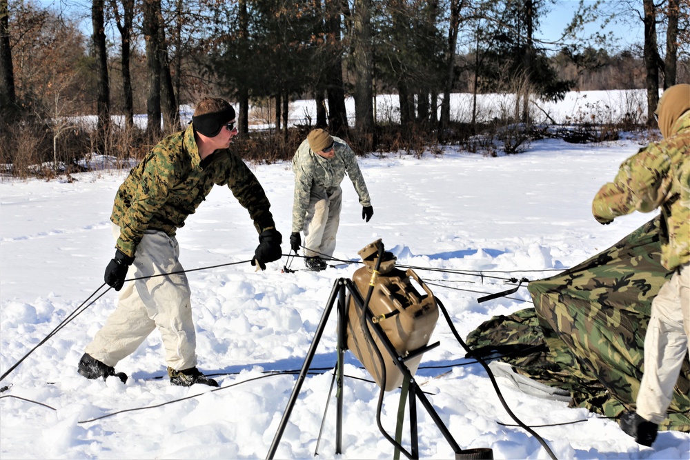 Cold-Weather Operations Course students practice building Arctic tent