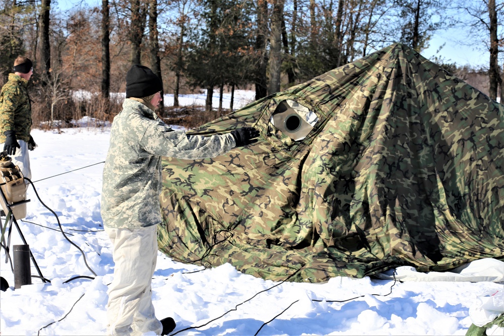 Cold-Weather Operations Course students practice building Arctic tent