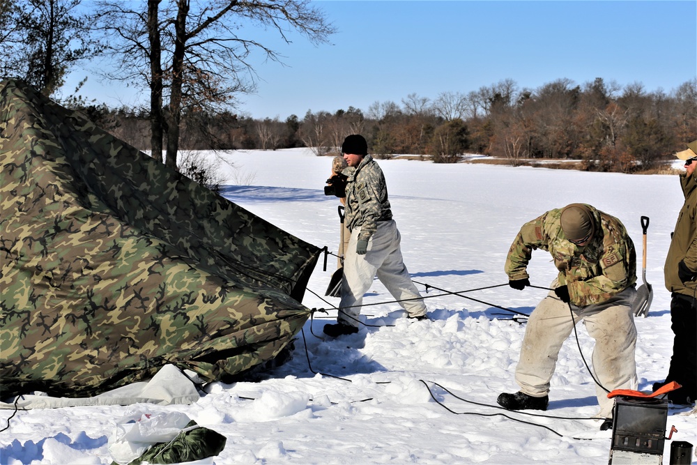 Cold-Weather Operations Course students practice building Arctic tent