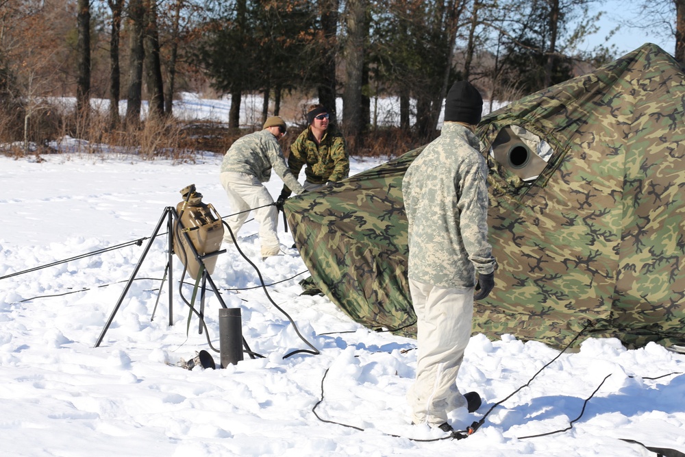 Cold-Weather Operations Course students practice building Arctic tent