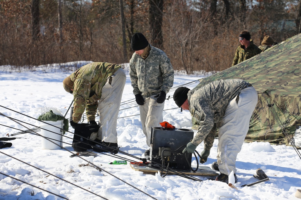 Cold-Weather Operations Course students practice building Arctic tent