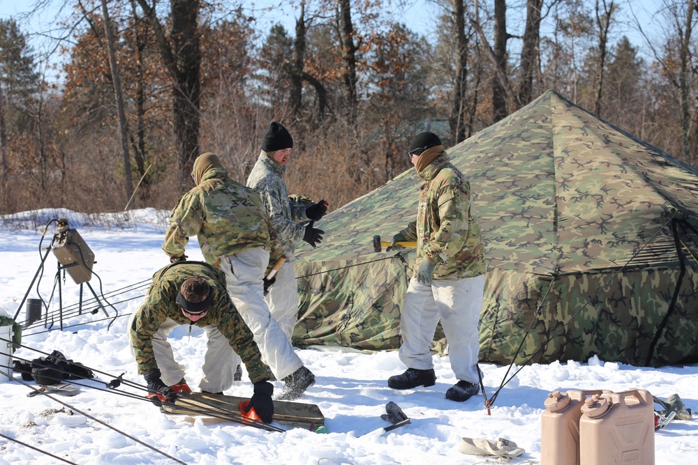 Cold-Weather Operations Course students practice building Arctic tent