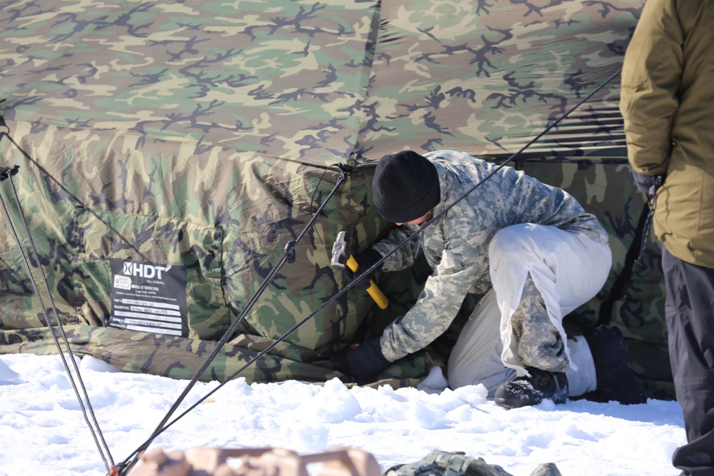 Cold-Weather Operations Course students practice building Arctic tent