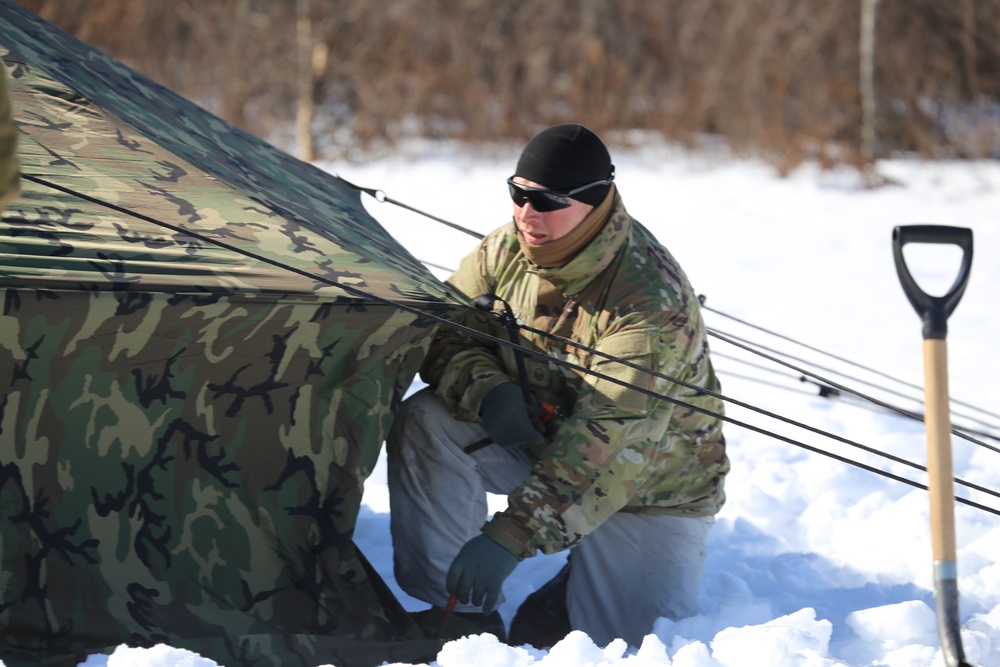 Cold-Weather Operations Course students practice building Arctic tent