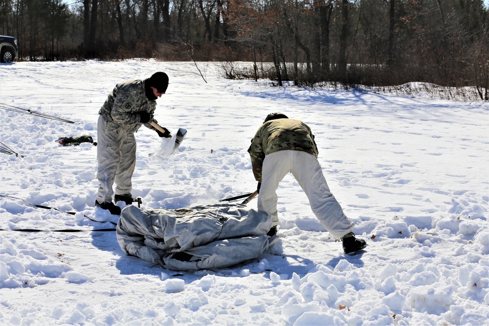 Cold-Weather Operations Course students practice building Arctic tent