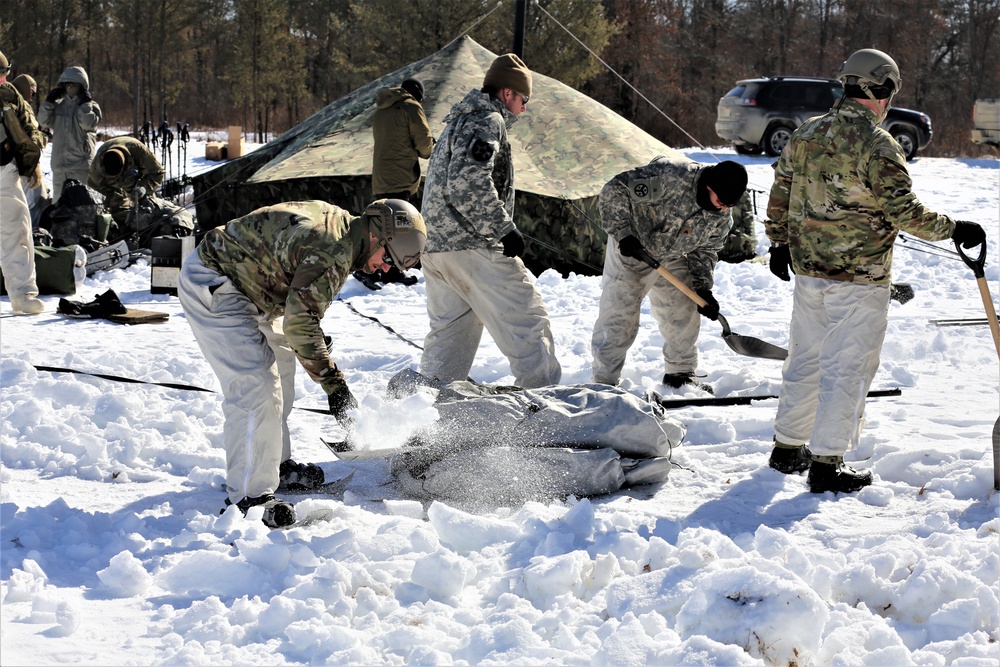 Cold-Weather Operations Course students practice building Arctic tent