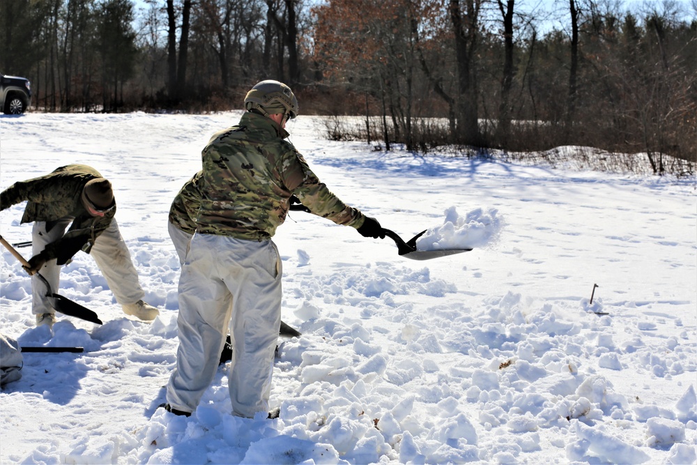 Cold-Weather Operations Course students practice building Arctic tent