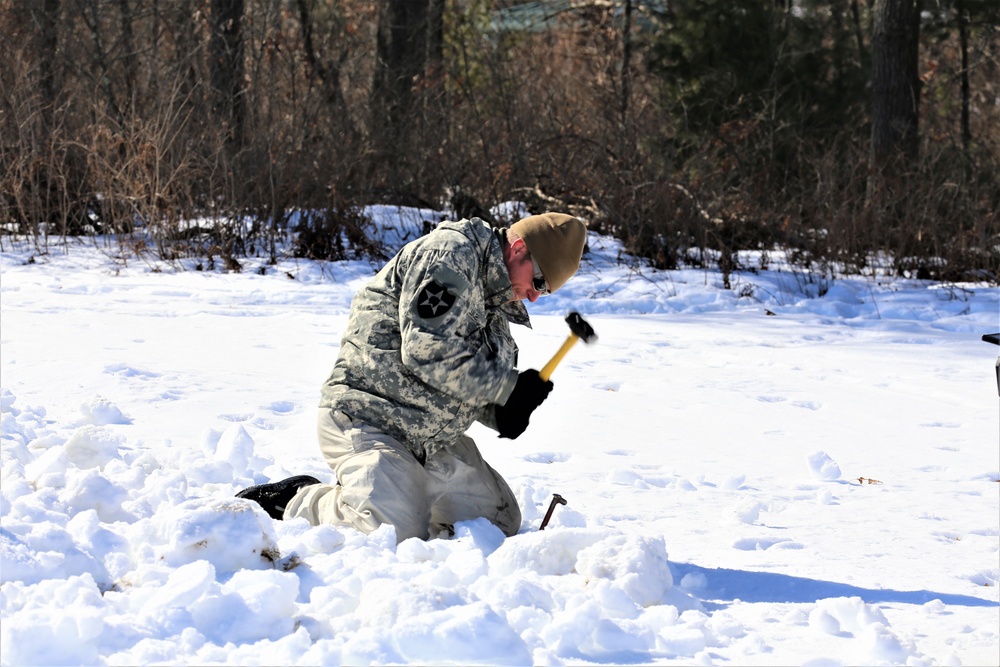 Cold-Weather Operations Course students practice building Arctic tent