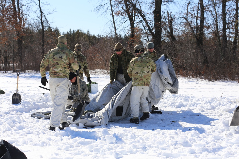 Cold-Weather Operations Course students practice building Arctic tent