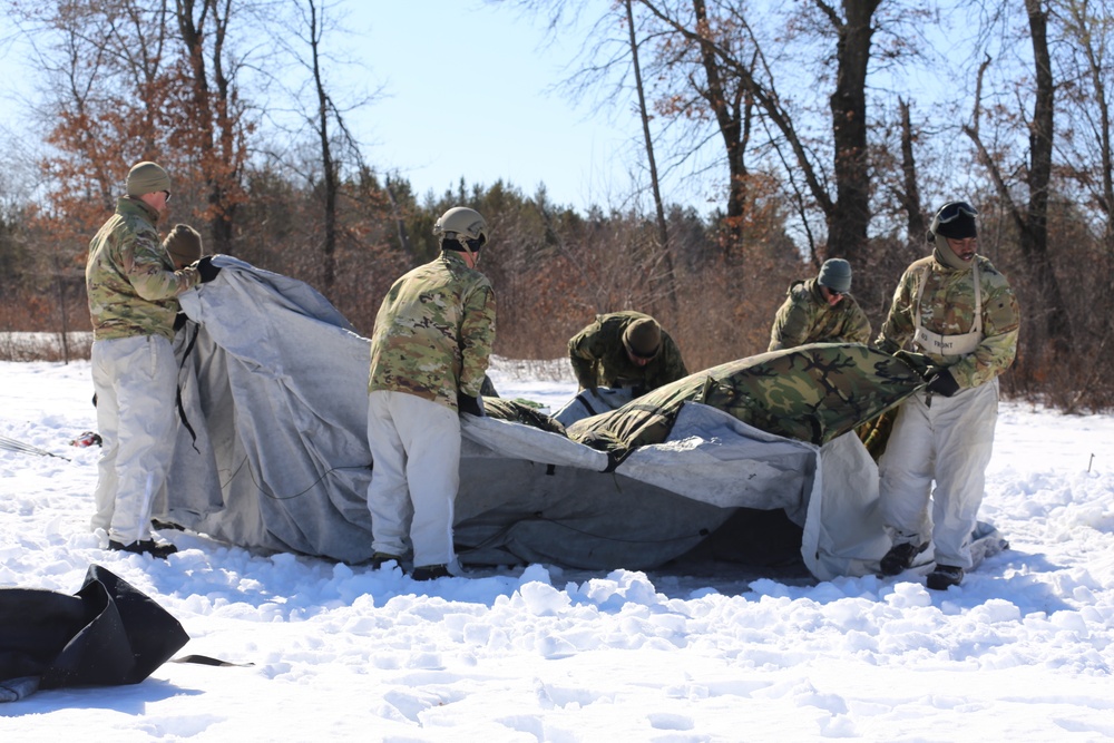 Cold-Weather Operations Course students practice building Arctic tent