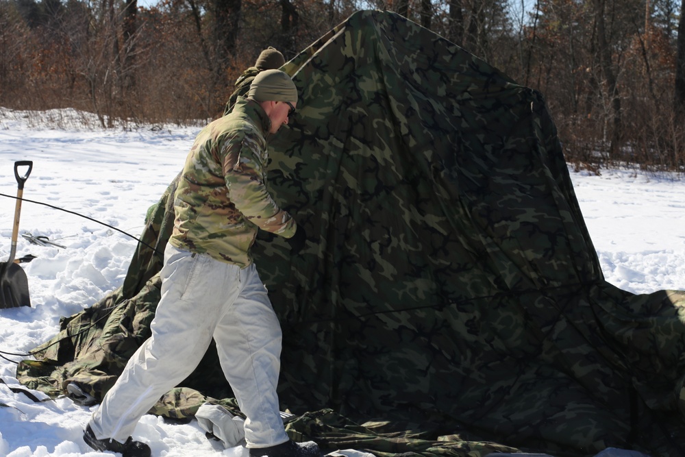 Cold-Weather Operations Course students practice building Arctic tent