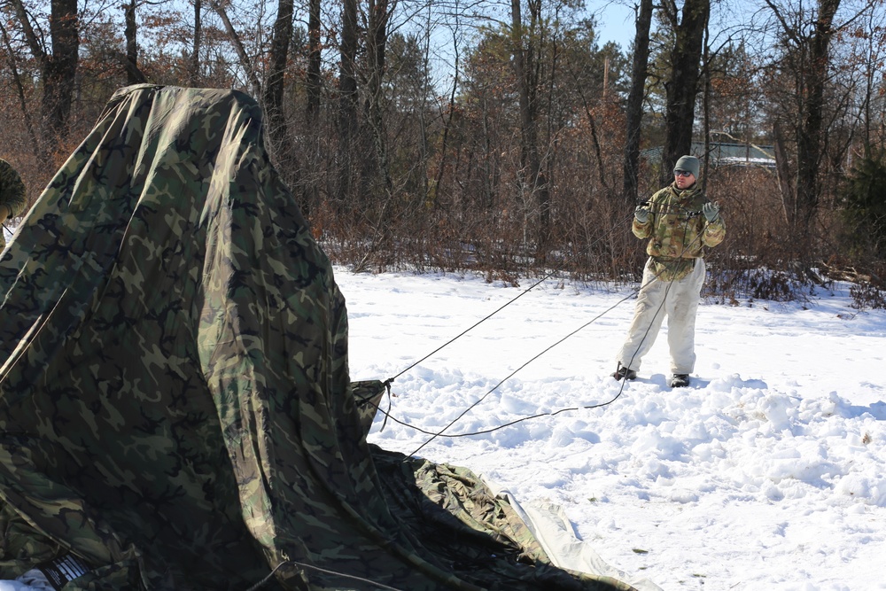 Cold-Weather Operations Course students practice building Arctic tent