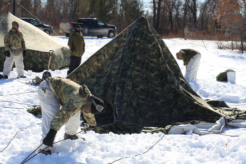 Cold-Weather Operations Course students practice building Arctic tent