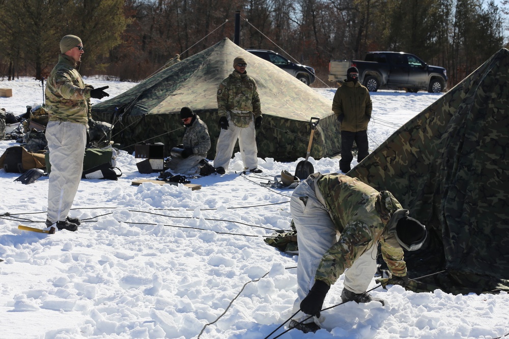 Cold-Weather Operations Course students practice building Arctic tent