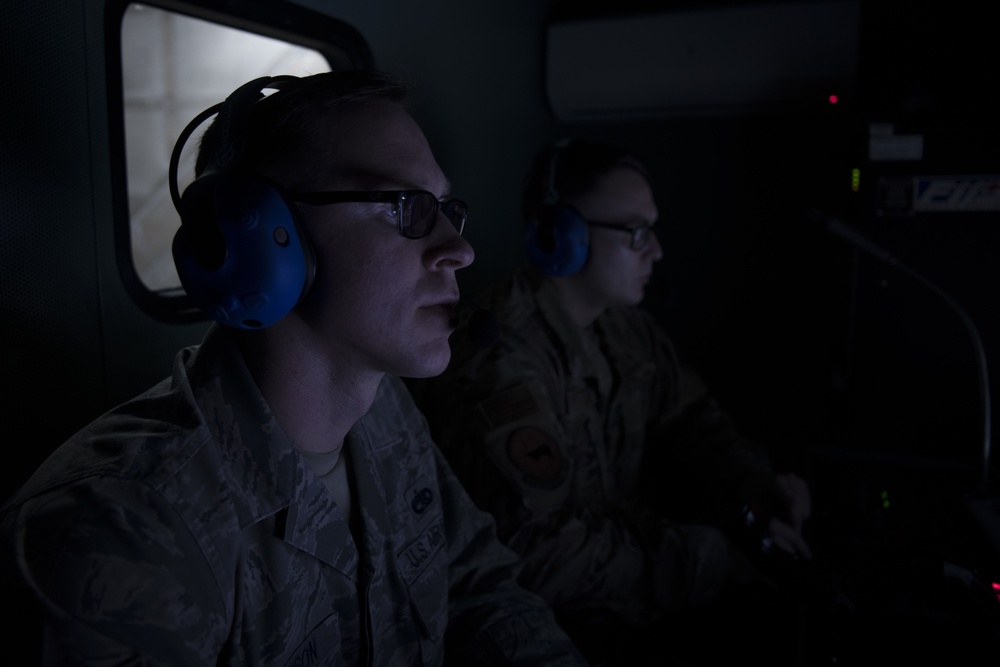 Airmen from the 192nd Wing and 1st Fighter Wing work together in a Hush House