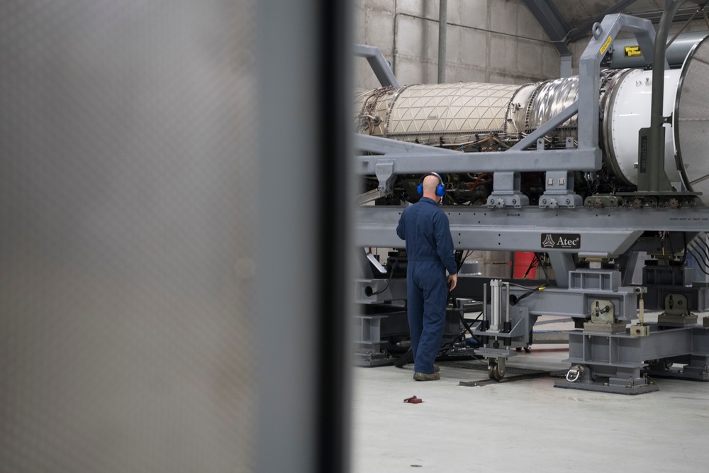 Airmen from the 192nd Wing and 1st Fighter Wing work together in a hush house