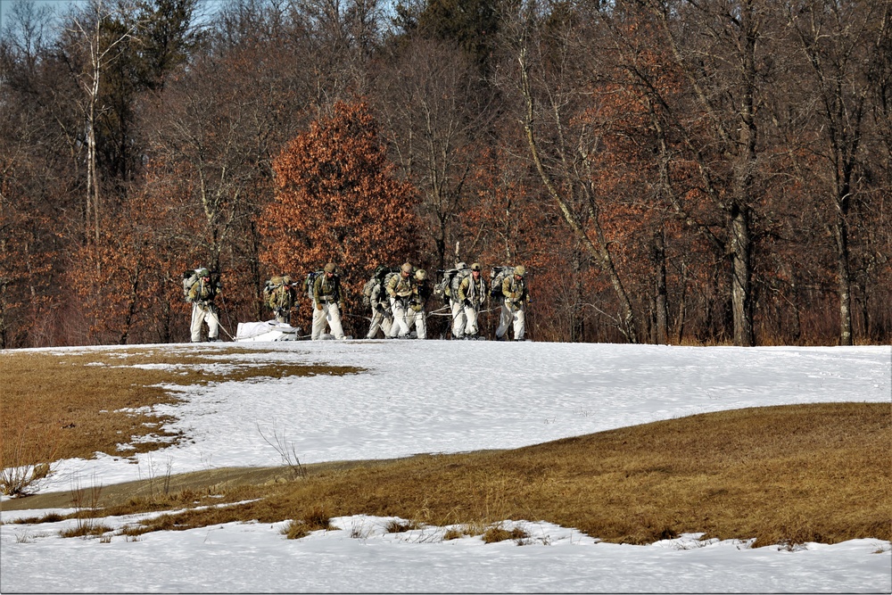 Fort McCoy Cold-Weather Operations Course students practice snowshoeing, ahkio sled use