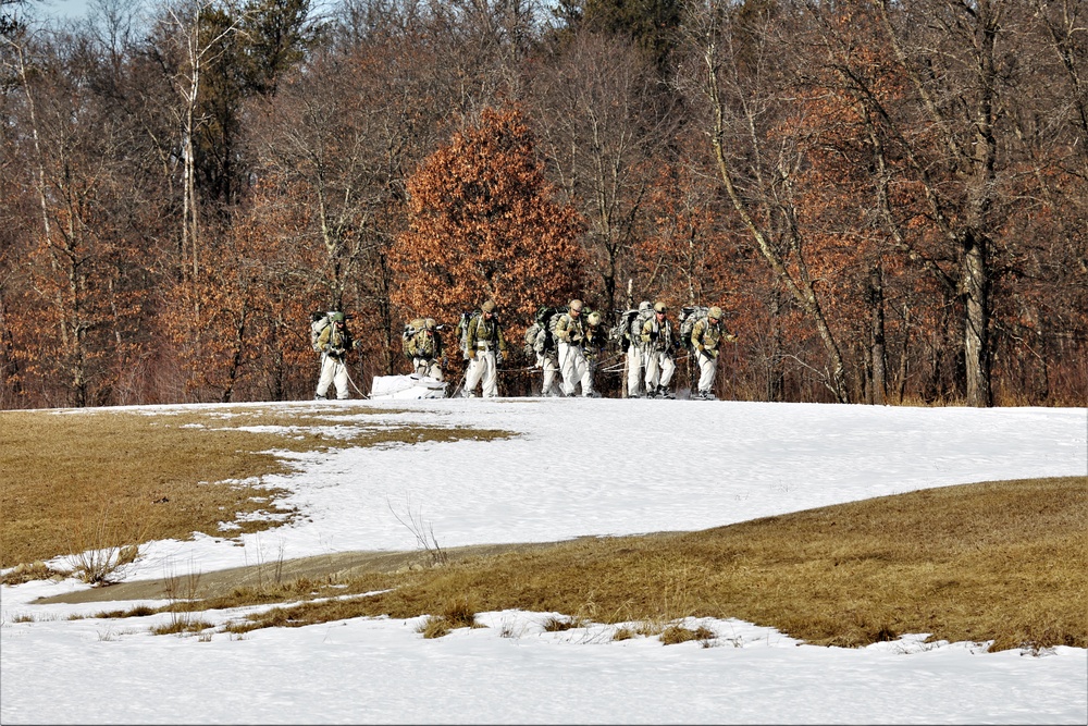 Fort McCoy Cold-Weather Operations Course students practice snowshoeing, ahkio sled use