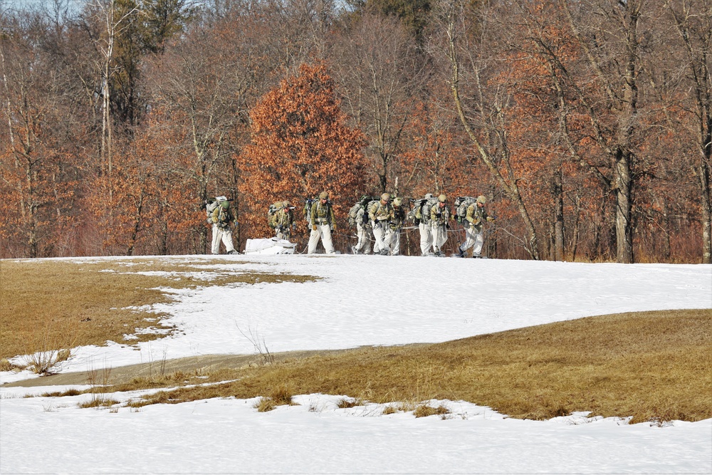 Fort McCoy Cold-Weather Operations Course students practice snowshoeing, ahkio sled use