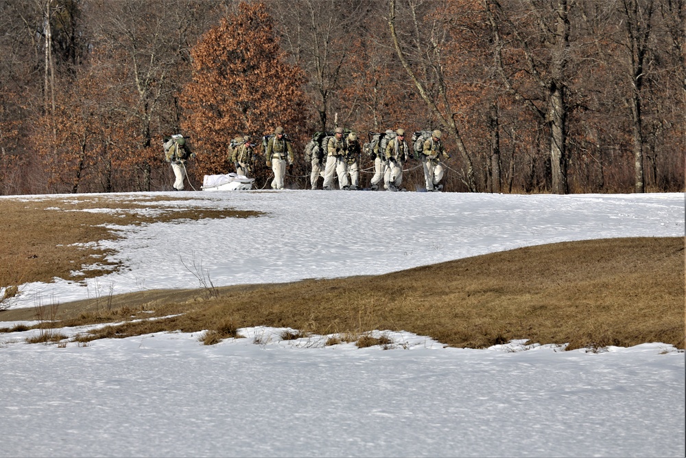 Fort McCoy Cold-Weather Operations Course students practice snowshoeing, ahkio sled use