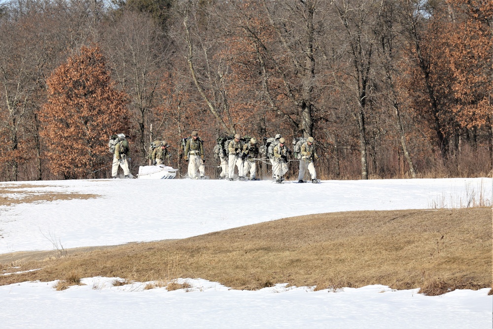 Fort McCoy Cold-Weather Operations Course students practice snowshoeing, ahkio sled use