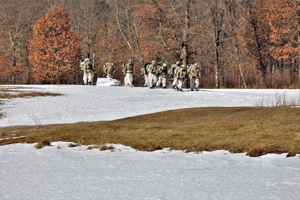 Fort McCoy Cold-Weather Operations Course students practice snowshoeing, ahkio sled use