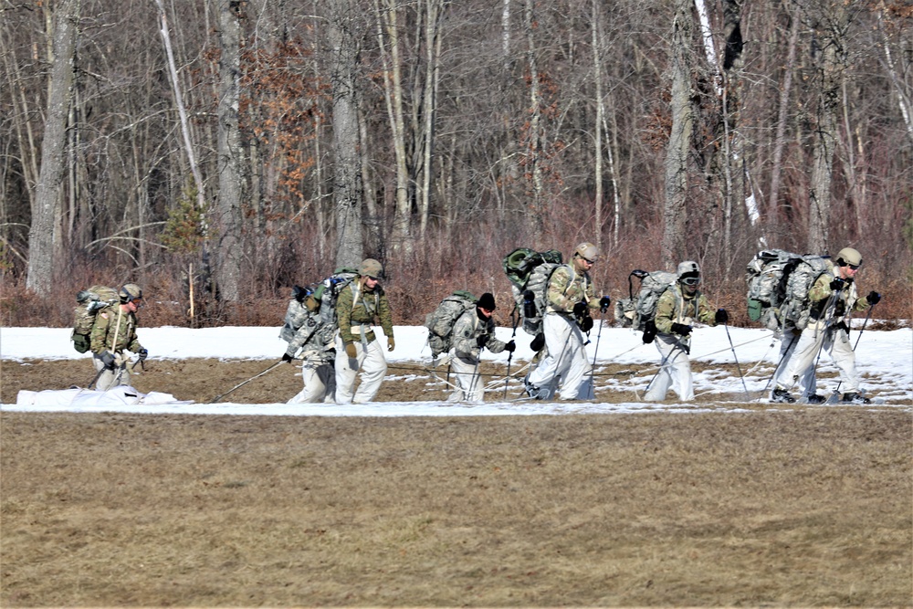 Fort McCoy Cold-Weather Operations Course students practice snowshoeing, ahkio sled use