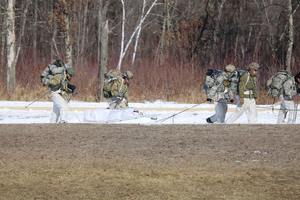 Fort McCoy Cold-Weather Operations Course students practice snowshoeing, ahkio sled use