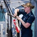 Sailor Prepares to Haul Flags