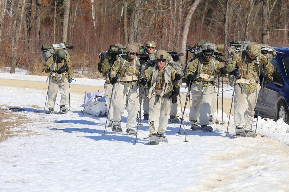 Fort McCoy Cold-Weather Operations Course students practice snowshoeing, ahkio sled use