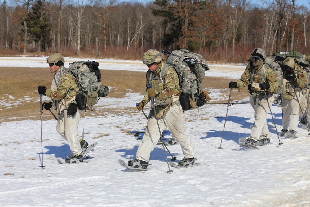 Fort McCoy Cold-Weather Operations Course students practice snowshoeing, ahkio sled use