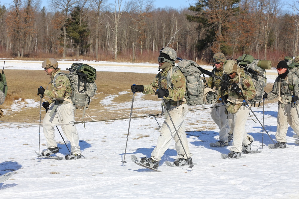 Fort McCoy Cold-Weather Operations Course students practice snowshoeing, ahkio sled use