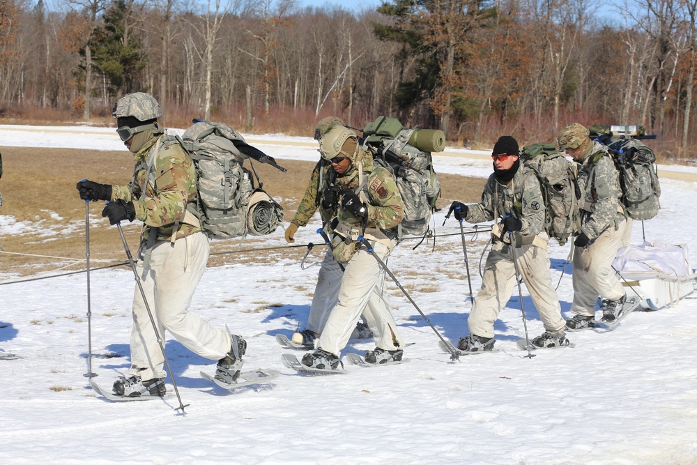 Fort McCoy Cold-Weather Operations Course students practice snowshoeing, ahkio sled use