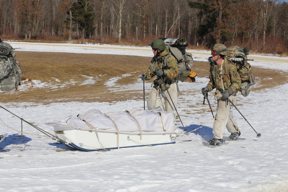 Fort McCoy Cold-Weather Operations Course students practice snowshoeing, ahkio sled use