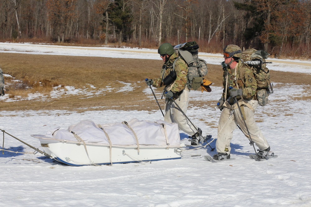 Fort McCoy Cold-Weather Operations Course students practice snowshoeing, ahkio sled use