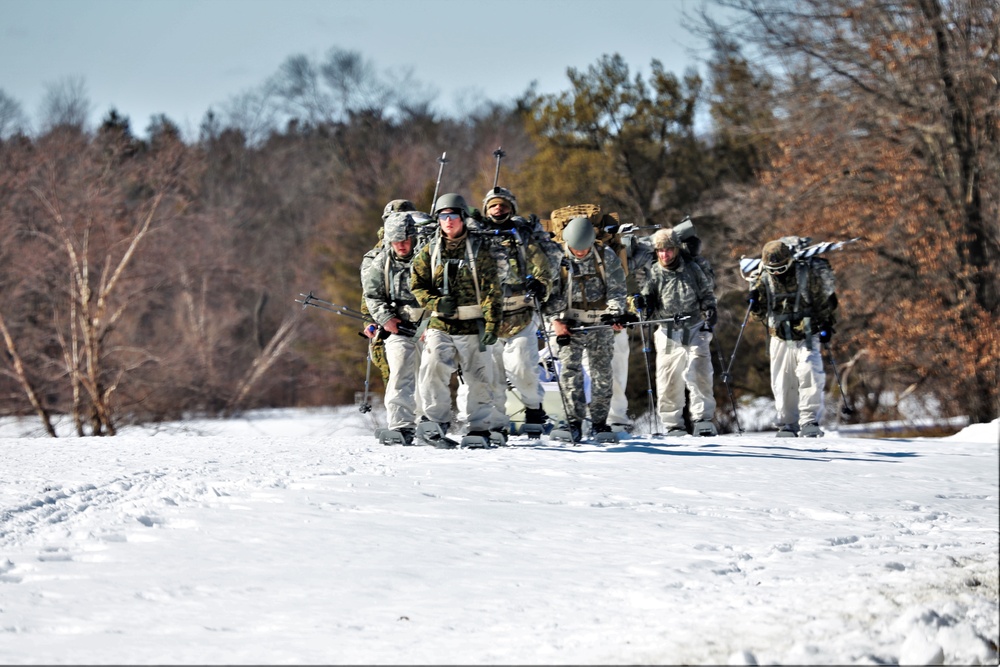 Fort McCoy Cold-Weather Operations Course students practice snowshoeing, ahkio sled use