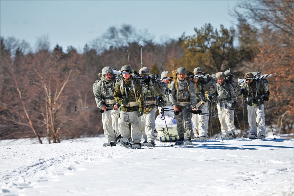 Fort McCoy Cold-Weather Operations Course students practice snowshoeing, ahkio sled use