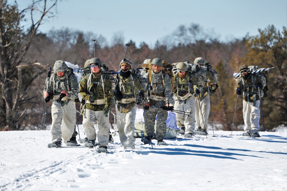 Fort McCoy Cold-Weather Operations Course students practice snowshoeing, ahkio sled use