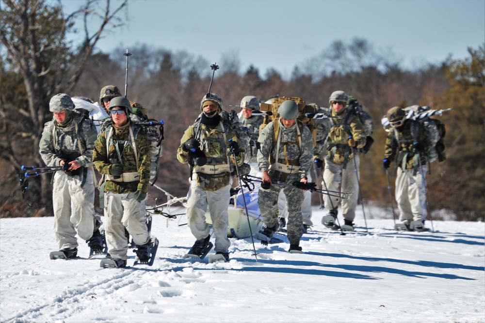 Fort McCoy Cold-Weather Operations Course students practice snowshoeing, ahkio sled use