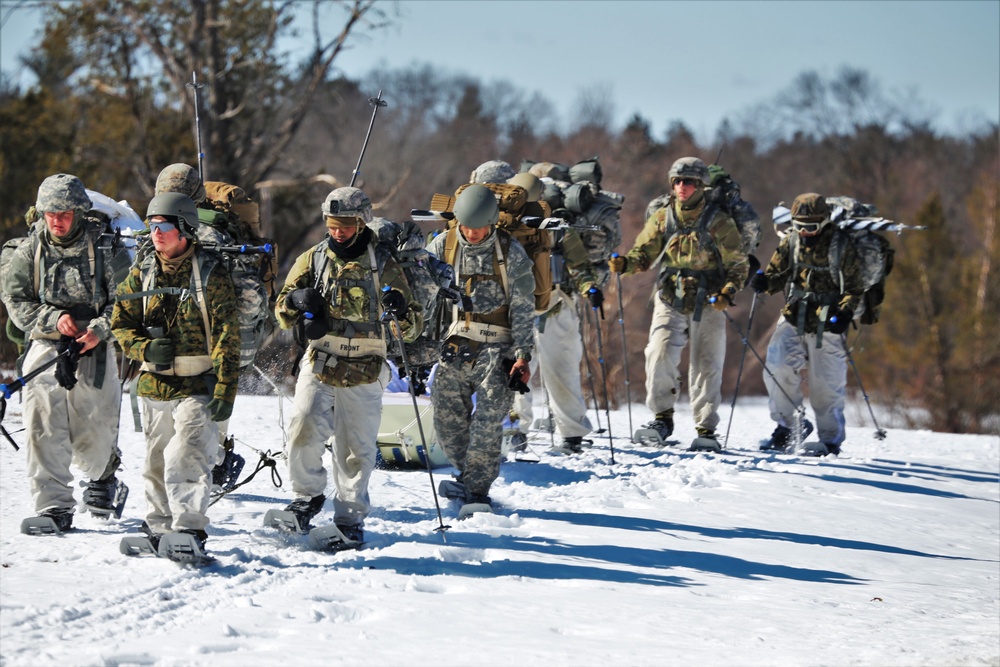 Fort McCoy Cold-Weather Operations Course students practice snowshoeing, ahkio sled use