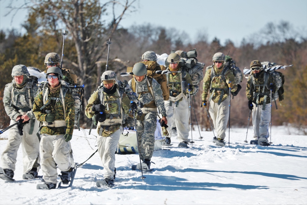 Fort McCoy Cold-Weather Operations Course students practice snowshoeing, ahkio sled use