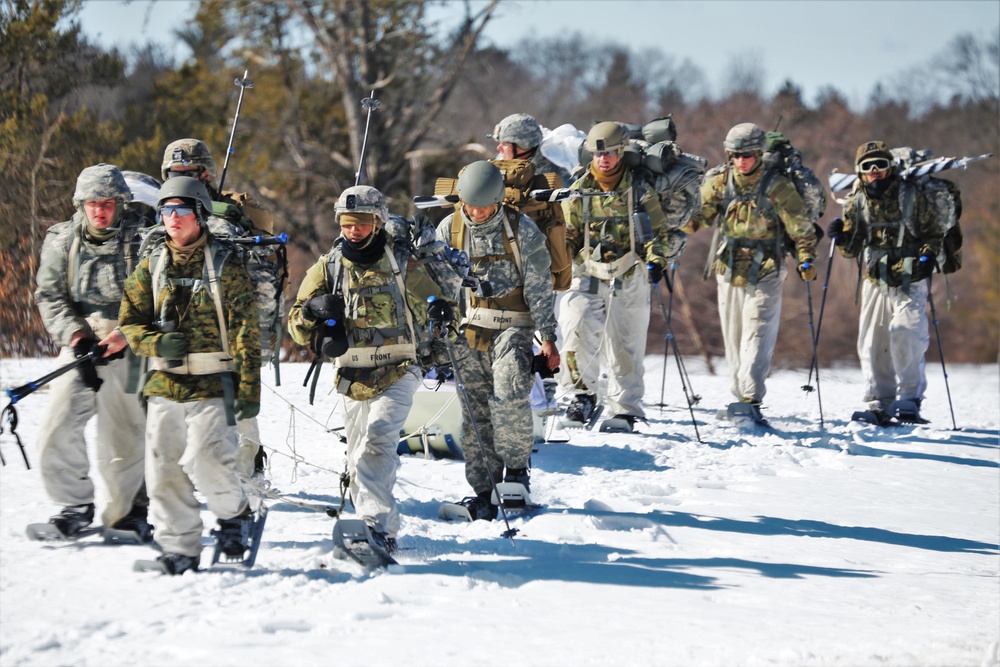 Fort McCoy Cold-Weather Operations Course students practice snowshoeing, ahkio sled use