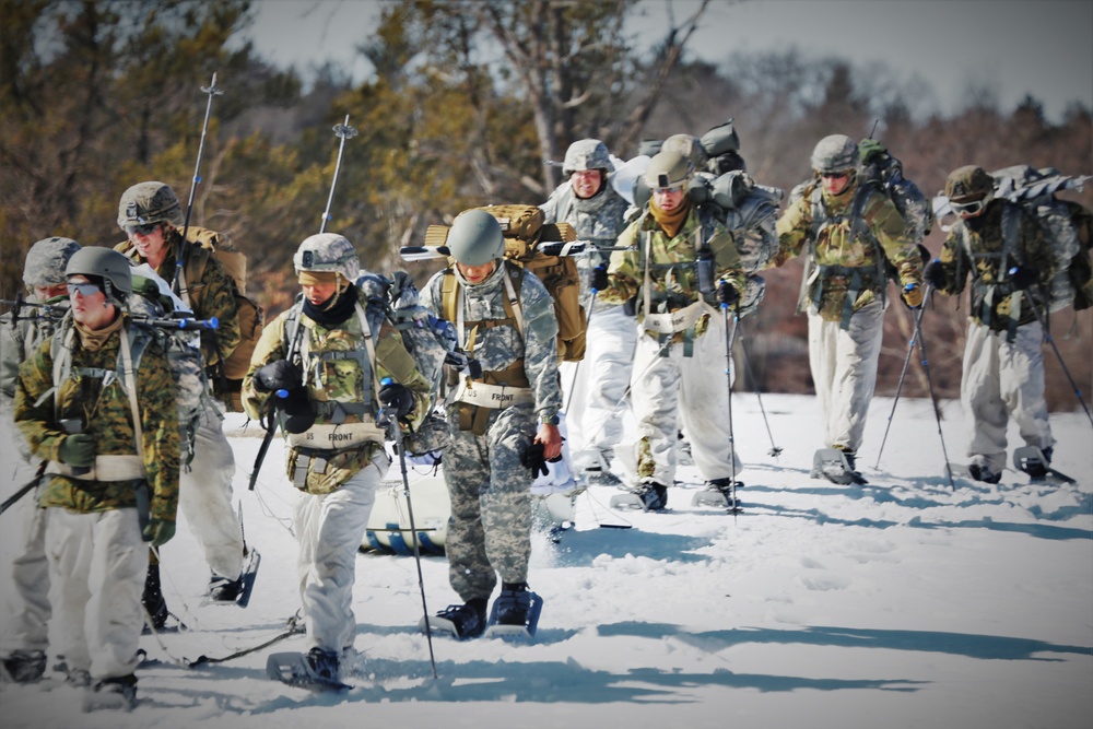 Fort McCoy Cold-Weather Operations Course students practice snowshoeing, ahkio sled use