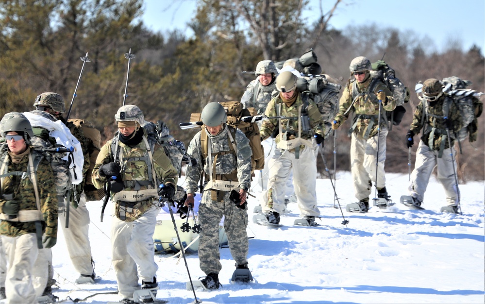 Fort McCoy Cold-Weather Operations Course students practice snowshoeing, ahkio sled use