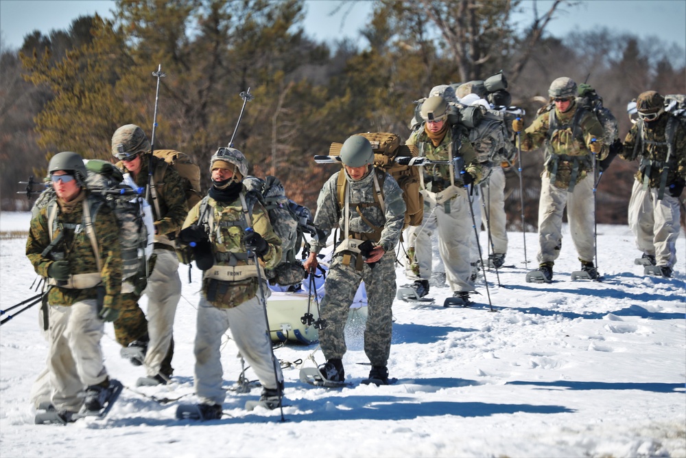 Fort McCoy Cold-Weather Operations Course students practice snowshoeing, ahkio sled use