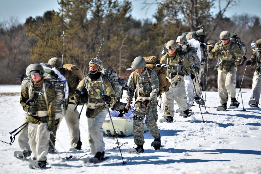 Fort McCoy Cold-Weather Operations Course students practice snowshoeing, ahkio sled use