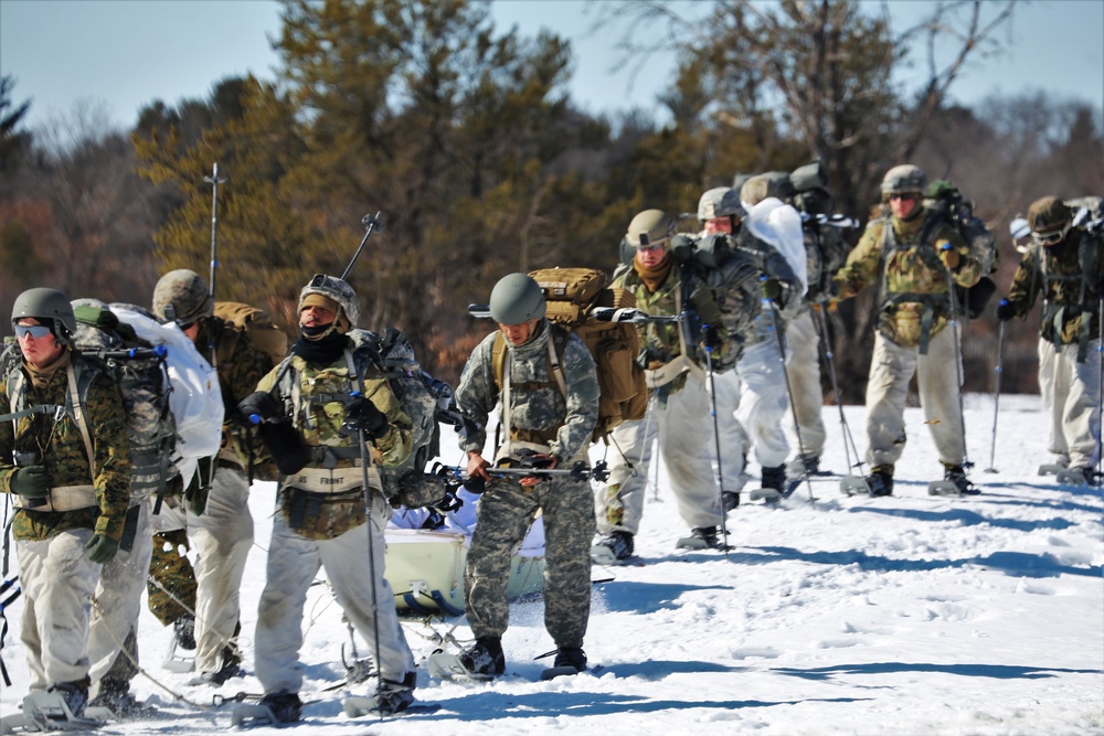 Fort McCoy Cold-Weather Operations Course students practice snowshoeing, ahkio sled use