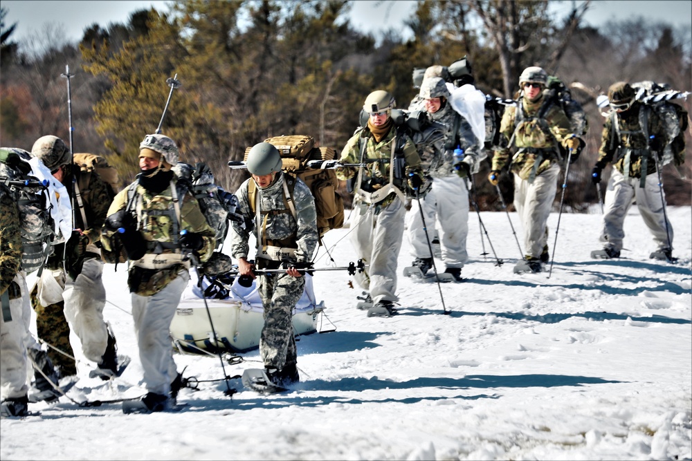 Fort McCoy Cold-Weather Operations Course students practice snowshoeing, ahkio sled use